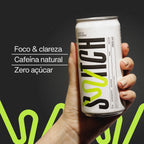 Lata de Switch sabor limão e gengibre sendo segurada por uma mão, sobre fundo escuro. À esquerda, aparecem os benefícios “Foco & clareza”, “Cafeína natural” e “Zero açúcar”.